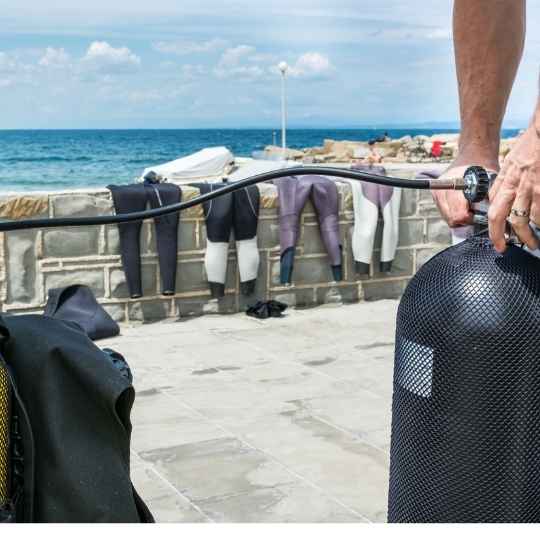 a diver preparing his scuba tank