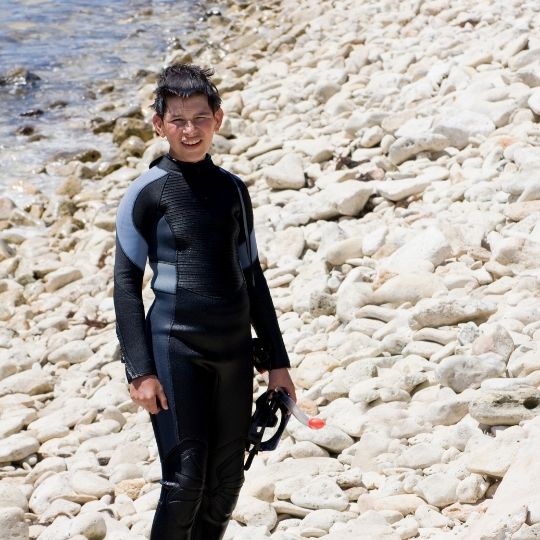 a kid in a wetsuit